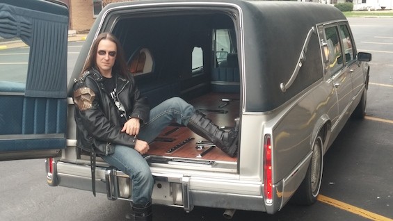 We Bite bassist Nikki Strychnine is dead serious about his new ride -- a 1990 Cadillac de Ville hearse. - NIKKI STRYCHNINE