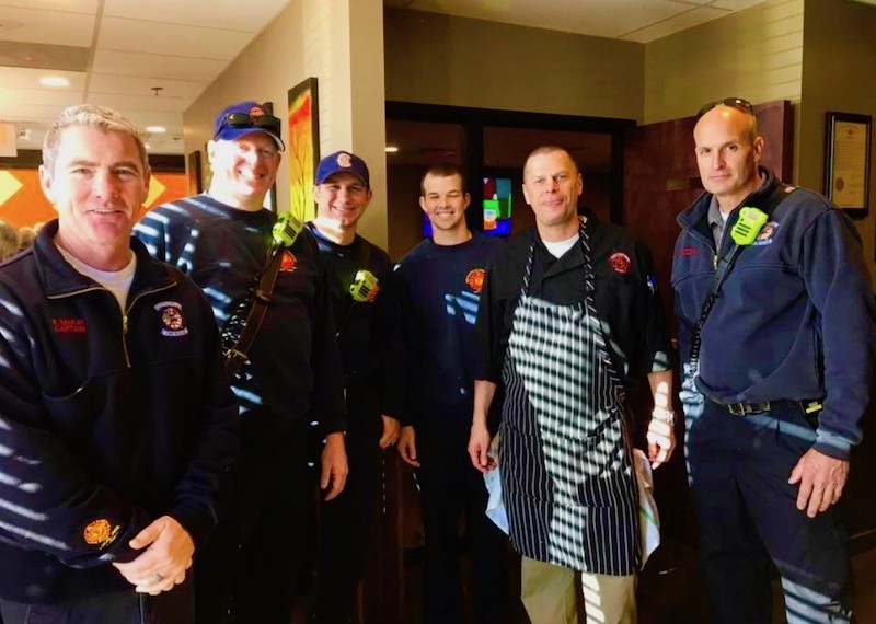 Scott Ellinger, second from right, with fellow Thanksgiving helpers. - COURTESY OF THE BRASS RAIL