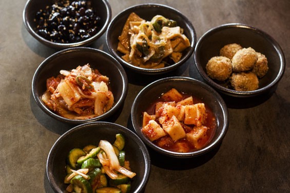 Sides at Seoul Q include an array of kimchi, beef croquettes and sweet black beans. - Mabel Suen