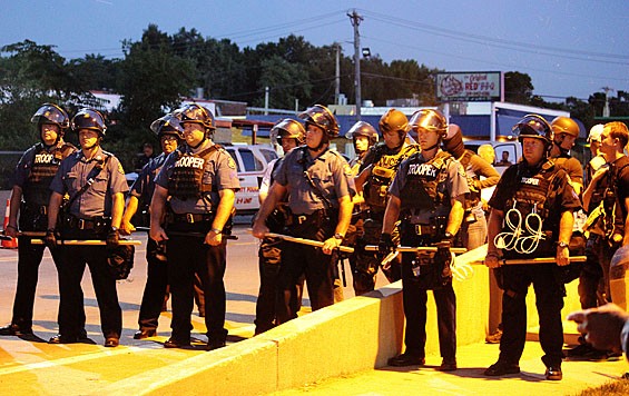 Officers in a picket line during the early August protests on West Florrisant Avenue. - DANNY WICENTOWSKI