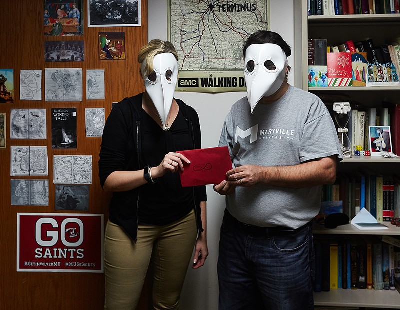 Donning "plague doctor" masks, professors Kyra Krakos and John Marino hold an envelope that will change the fates of their eighteen students. - THEO WELLING
