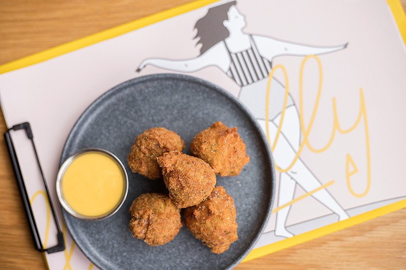 Deviled crab fritters are delightful shellfish puffs, made even more so when dipped into the accompanying passion fruit mustard. - MABEL SUEN