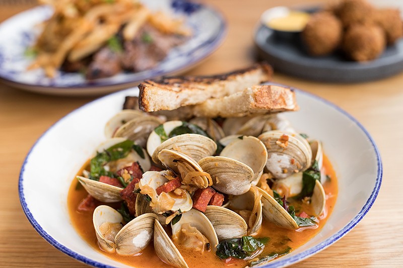 ”Wu Tang Clams” are served with Portuguese sausage in a white wine broth. - MABEL SUEN