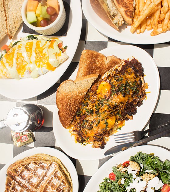 An array of Kingside's food, including a spinach omelet, grilled chicken Cuban sandwich, the "Kingside Slider," waffled French toast and kale salad. - Mabel Suen
