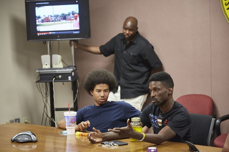Franks, right, argues a point to a police minority-recruitment class as instructor Sgt. Bill Clinton stands in the background. - Steve Truesdell