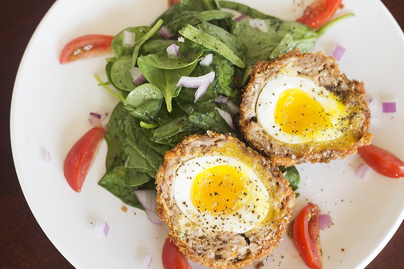 The Scotch egg features a soft-boiled egg wrapped in sausage and coated in breadcrumbs. - Mabel Suen