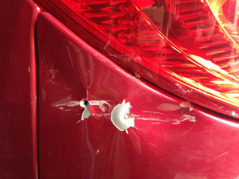 A con man used a screwdriver and hammer to punch two holes below the taillight to 'fix' a dent. - Doyle Murphy