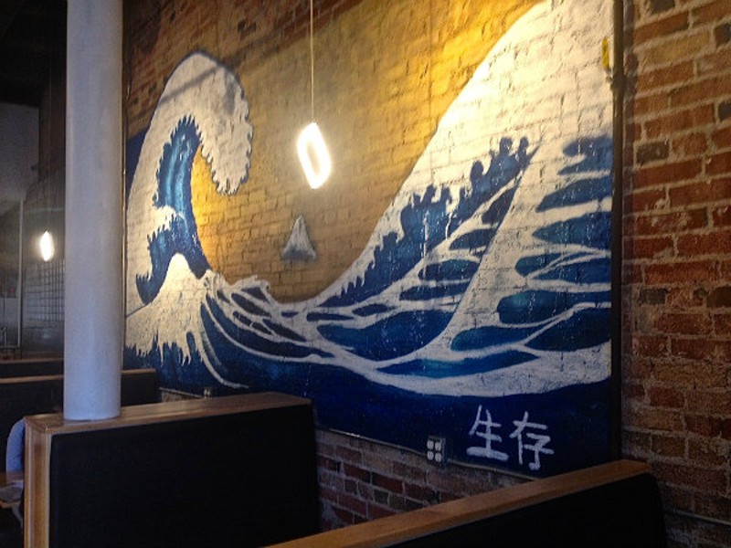 The tsunami mural brings bright colors to the wall at Midtown Sushi. - Emily Higginbotham