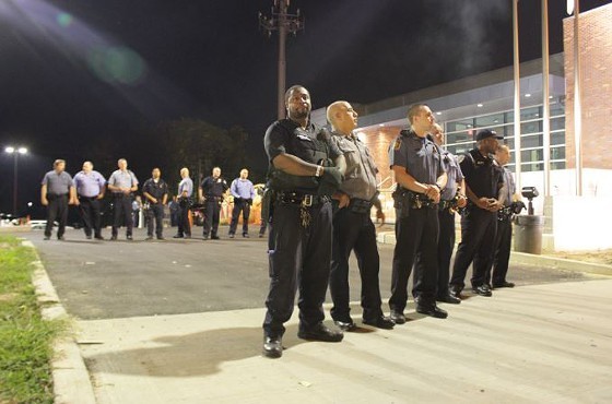 Officers stand guard over the Ferguson Police Department in September 2014 - Photo by Danny Wicentowski