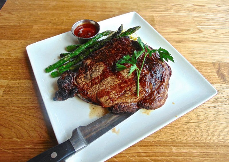 The Delmonico ribeye is aged for 28 days before it hits the grill. - Emily Higginbotham