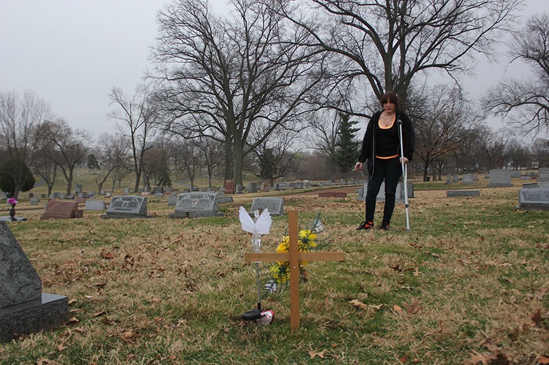 Peggy Cobb visits the grave of her son, James Cobb Jr., for the first time since his funeral. - PHOTO BY DOYLE MURPHY