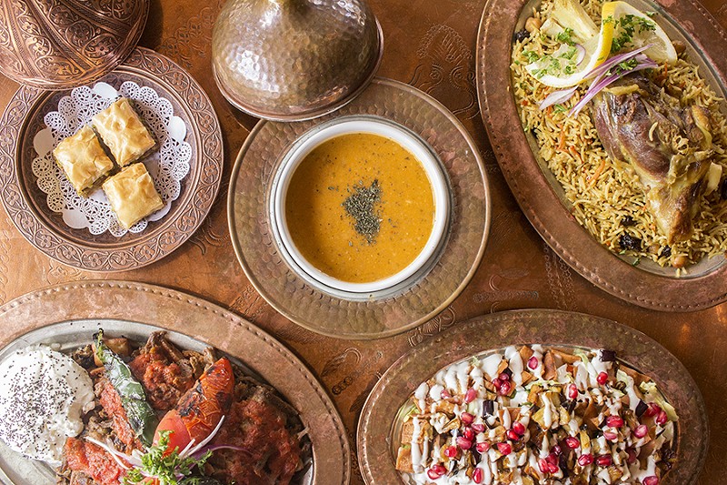 A selection of dishes from Sheesh, including lamb biryani, baklava and the “Sheesh Special” salad. - PHOTO BY MABEL SUEN