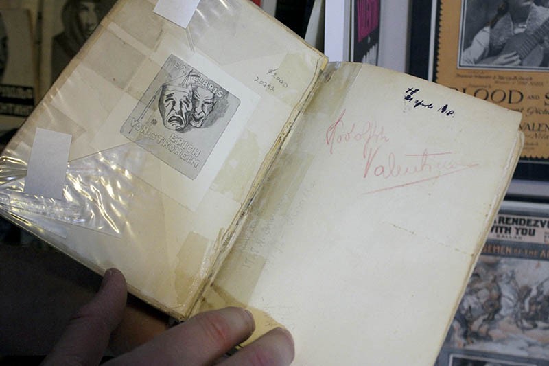 A book from Valentino's library, with his name handwritten inside. - PHOTO BY ALLISON BABKA