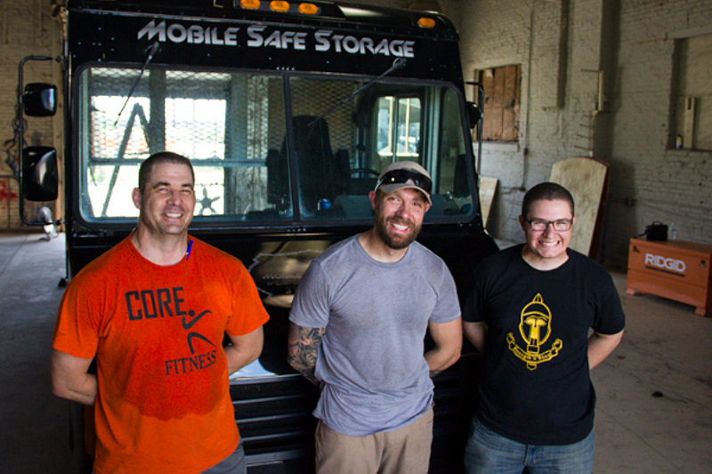Justin Hulsey, center, has an armored van and a team of veterans to protect it. What he doesn't have is a vending license. - Photo by Danny Wicentowski
