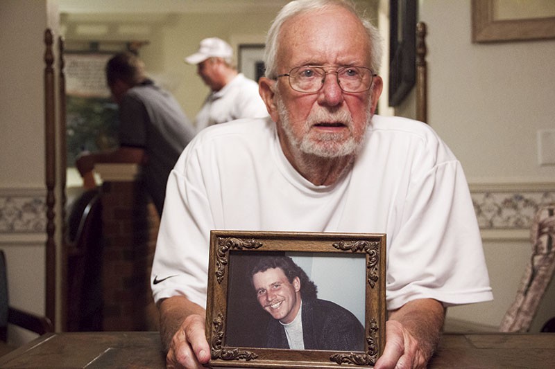 In Ste. Genevieve, Patrick Prosser, 80, holds a photo showing his son Tim as he looked before meth derailed his life. - PHOTO BY DANNY WICENTOWSKI
