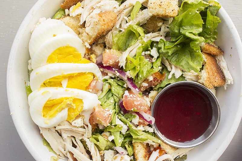 A salad topped with chicken, hard-boiled eggs, red onion and croutons. - PHOTO BY MABEL SUEN