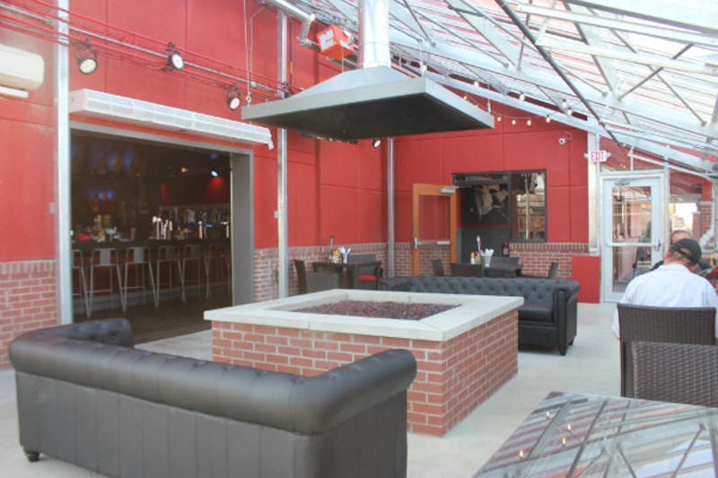 Outdoor seating includes leather couches and a  fireplace. - Cheryl Baehr