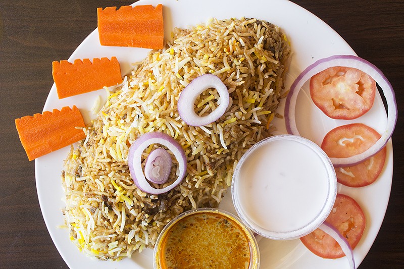 Chicken hyderabadi dum biryani features meat marinated with spices and yogurt and sandwiched between layers of basmati rice. - PHOTO BY MABEL SUEN