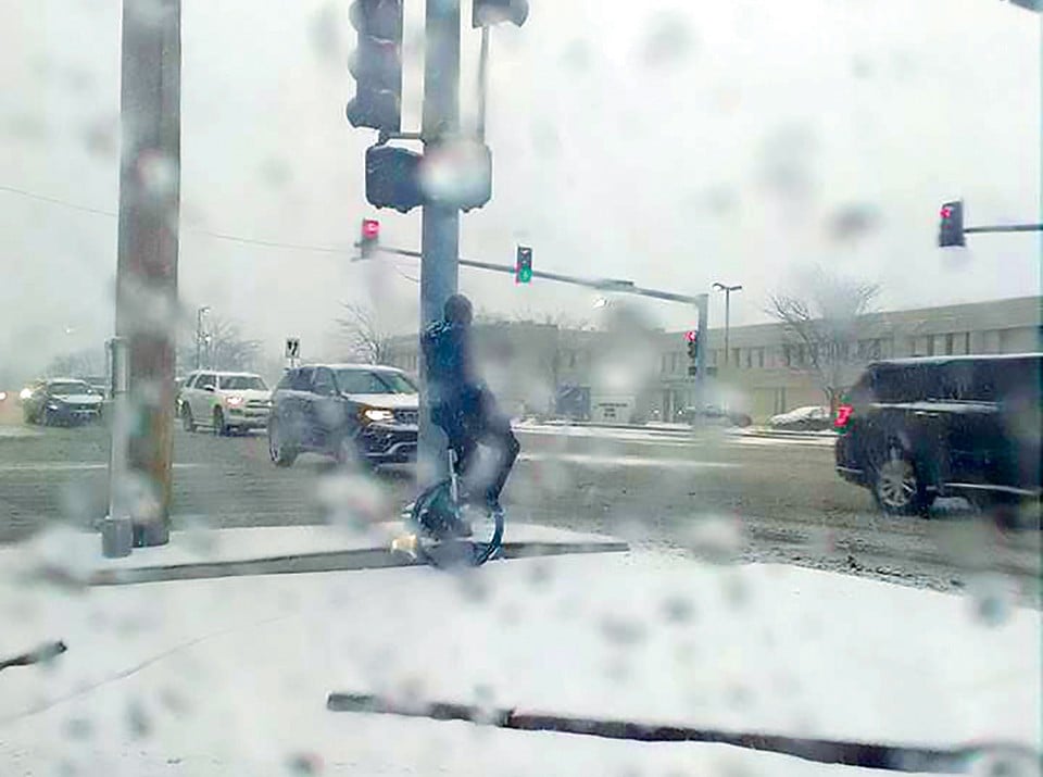 A passing driver took this photo as proof there really was a unicyclist in the snowstorm. - COURTESY JANE REDINGTON