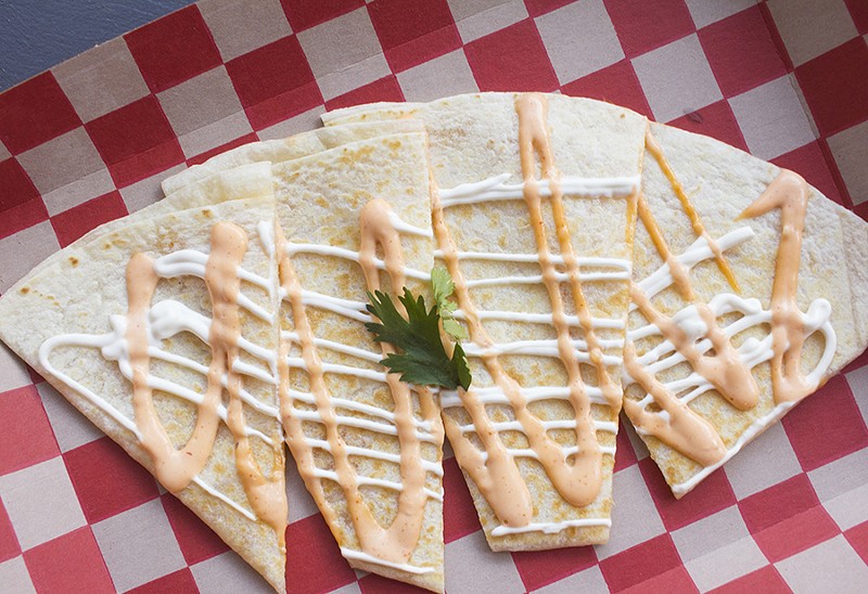 The cheese quesadilla is topped with sour cream and aioli. - PHOTO BY MABEL SUEN