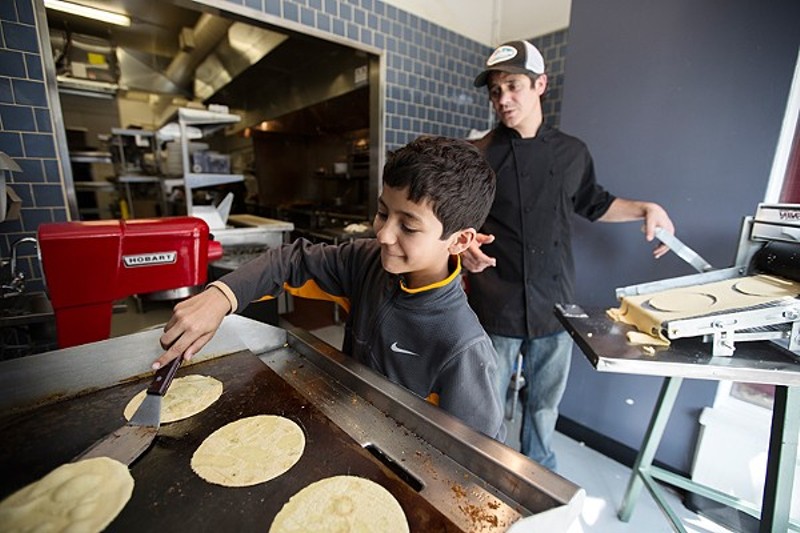 Mission Taco Chef-Owner Jason Tilford with his son, then 10, in the kitchen. The taco joint is great for date night — but also surprisingly accommodating to young families. - PHOTO BY JENNIFER SILVERBERG
