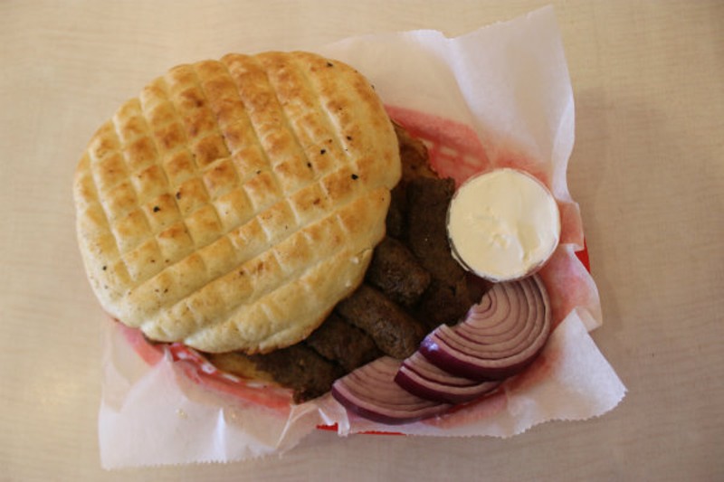Yapi's signature cevapi, served with griddled flatbread, onions and sour cream. - Cheryl Baehr