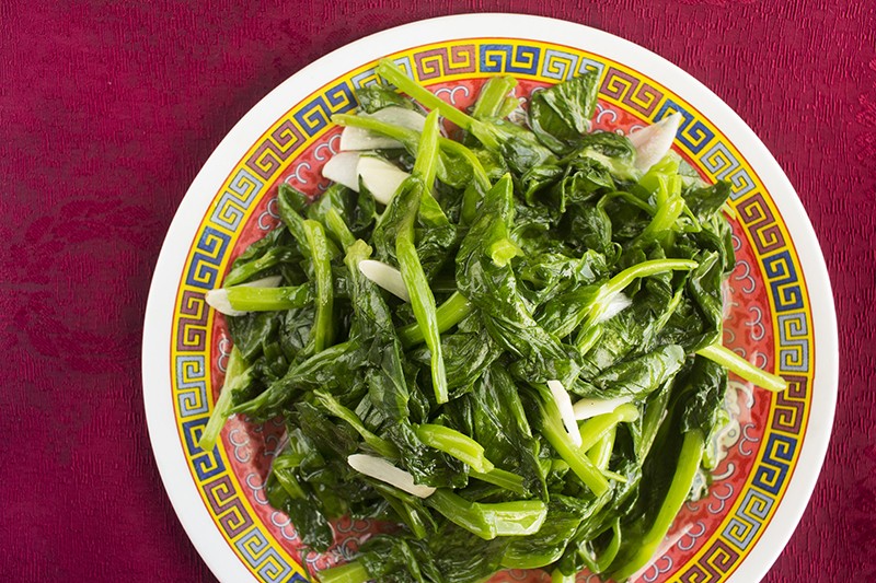 Snow pea tips: Snow pea leaves sautéed with garlic and sesame oil. - PHOTO BY MABEL SUEN