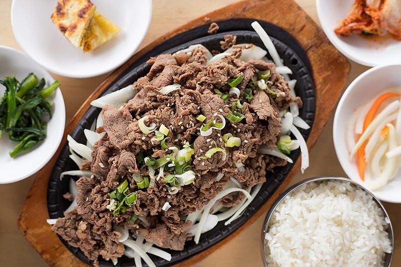 Bulgogi is a Korean BBQ dish featuring one pound of grilled thinly sliced prime ribeye beef marinated in savory or spicy sauce, served on a bed of onions. - MABEL SUEN
