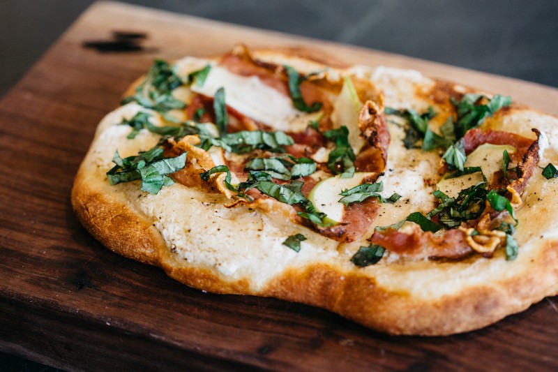 Flatbread topped with prosciutto, ricotta, apple and basil. - RJ HARTBECK