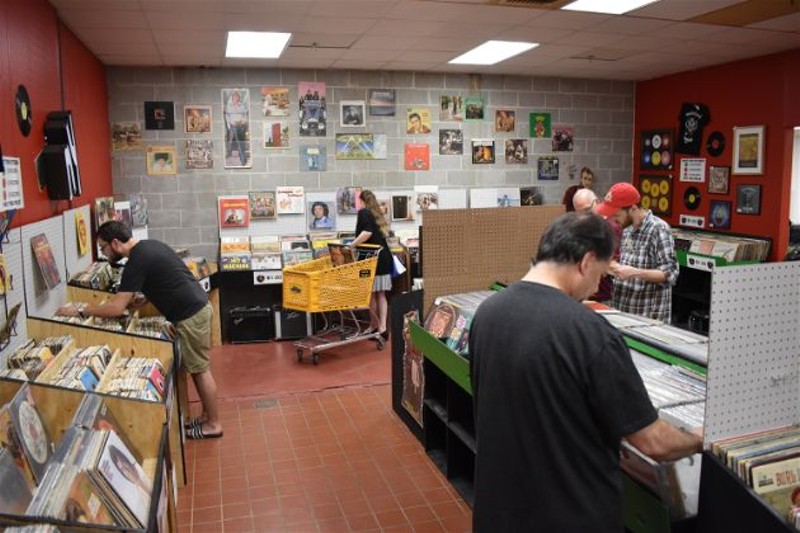Vinyl enthusiasts dig through the crates at SOHO's grand opening. - DANIEL HILL