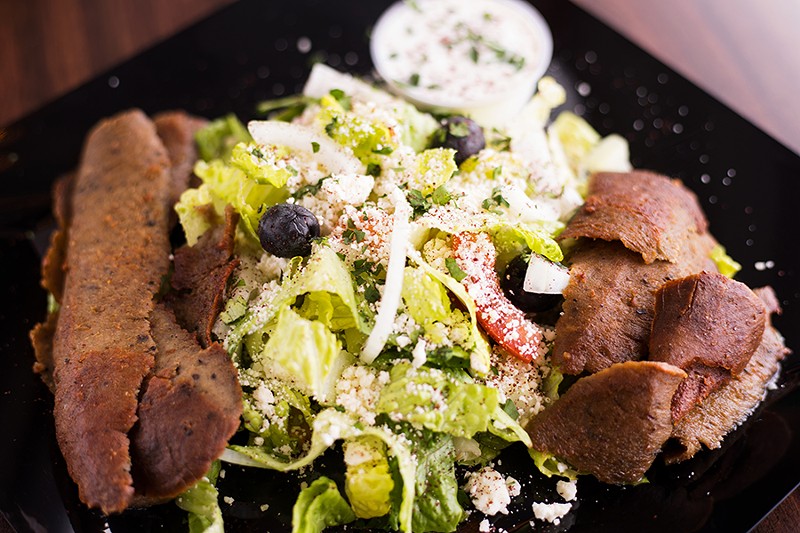 Greek salad is topped with olives, feta cheese, Greek dressing and gyro slices. - MABEL SUEN