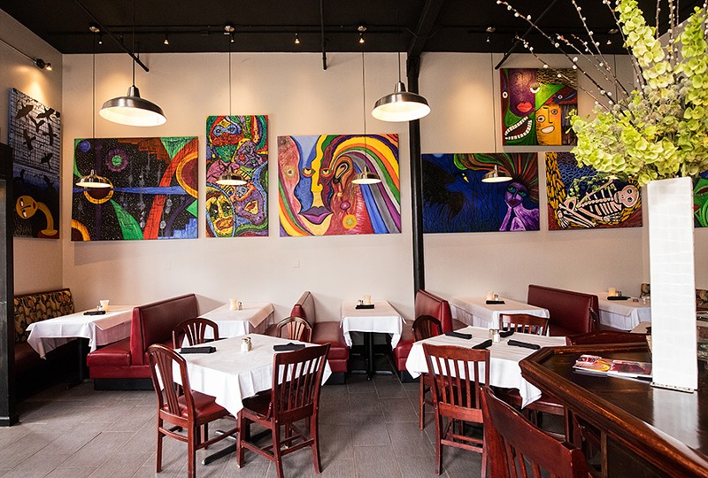 Cocina Latina’s dining area features bright paintings. - MABEL SUEN