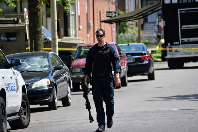 An officer leaves the scene of a five-hour standoff in Tower Grove South. - DOYLE MURPHY