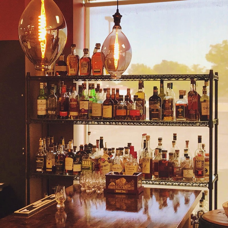 Whiskey, scotch, bourbon, rye and more line the shelves at (IN)Famous Bar inside The Wine & Cheese Place in Clayton. - Vijay Shroff