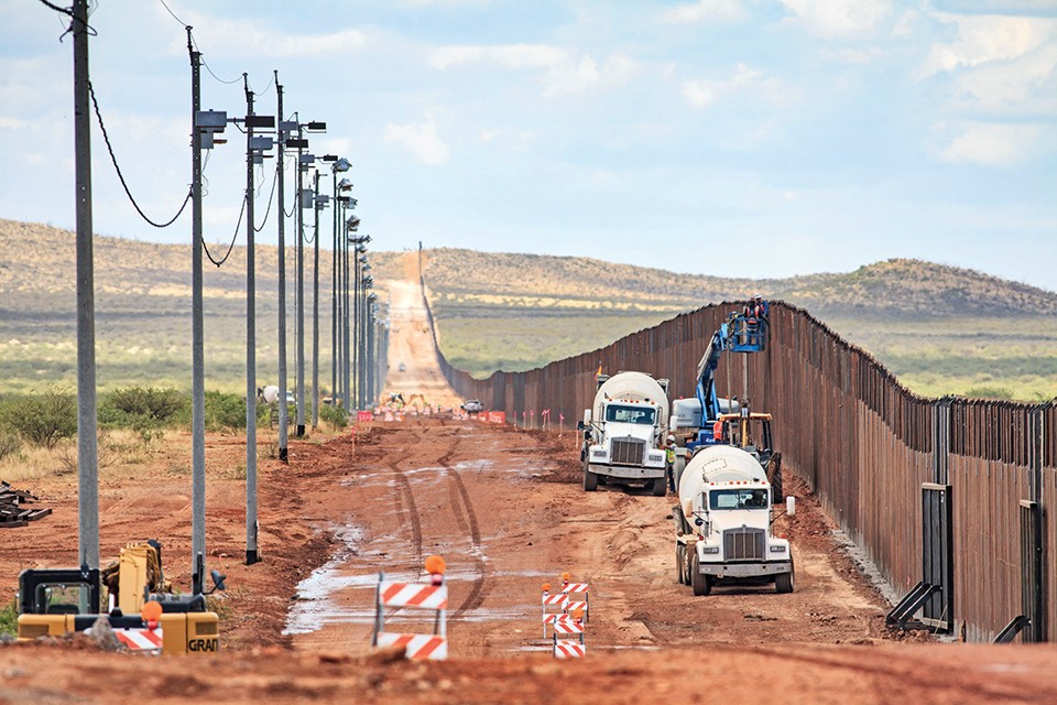 Repairmen attend to a section of the border wall near Naco, Arizona. - JOSHUA ROWAN