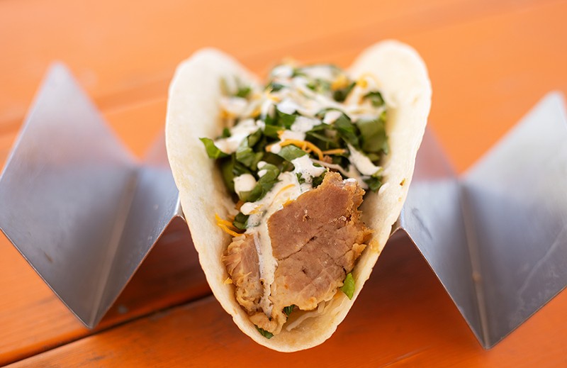 "Tito Puerco" taco with slow-simmered Cuban style citrus and garlic pork. - MABEL SUEN