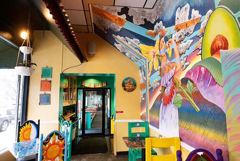 The colorful walls provide a sunny backdrop for even more colorful artwork — photographs, paintings and a beautiful mural depicting two traditionally-dressed Mexican women surrounded by flowers, fruits and vegetables. - MABEL SUEN
