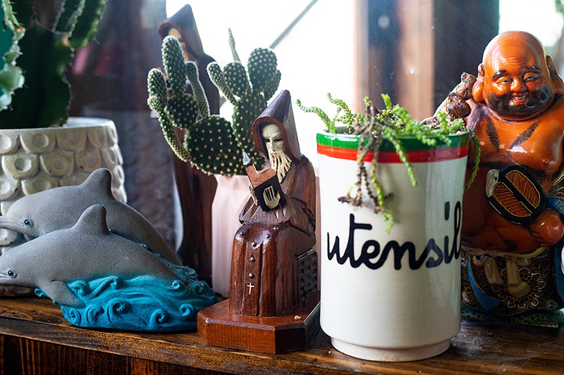 Decor in the dining room includes vibrant collectibles and cacti. - MABEL SUEN