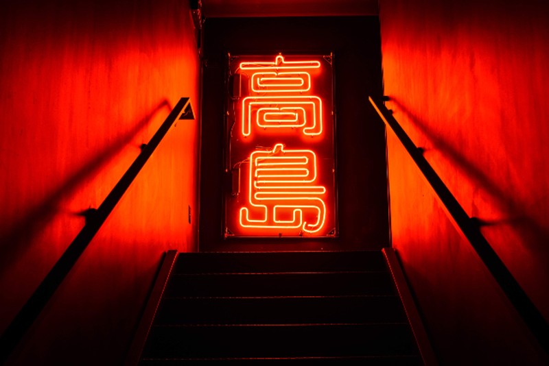 Guests are greeted to the second floor lounge area with a striking neon light. - TRENTON ALMGREN-DAVIS