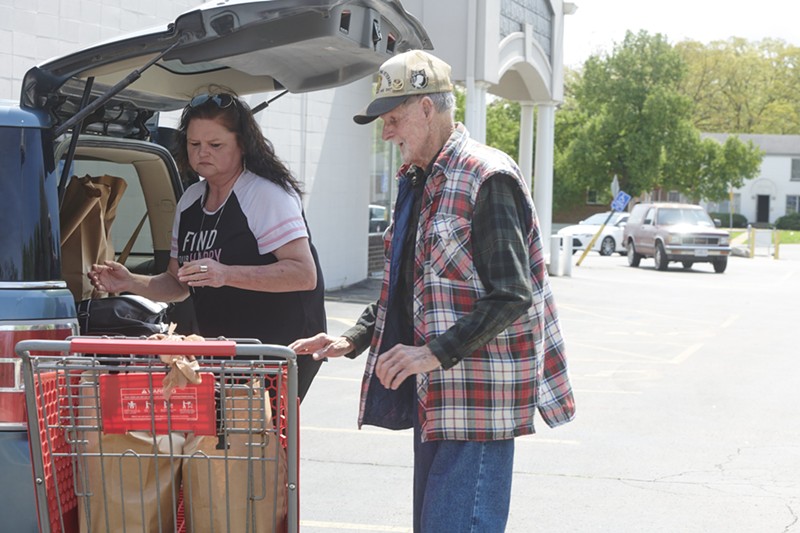 Caregiver Denise Phelps helps her 85-year-old uncle, William Speck, with groceries  from Feed My People  on April 24 in Lemay. - MARY BUTKUS