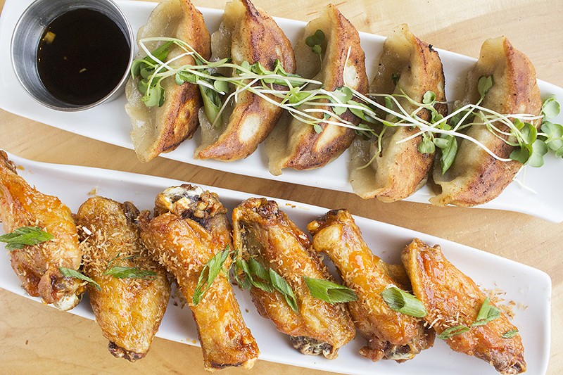 Pan-seared duck dumplings and ginger-coconut chicken wings. - PHOTO BY MABEL SUEN