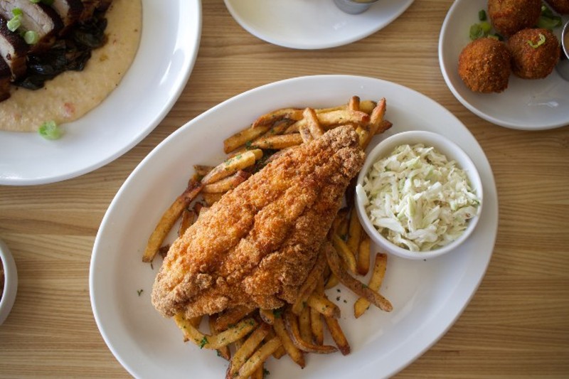 Cornbread-coated catfish is served with slaw, fries and remoulade. - CHERYL BAEHR
