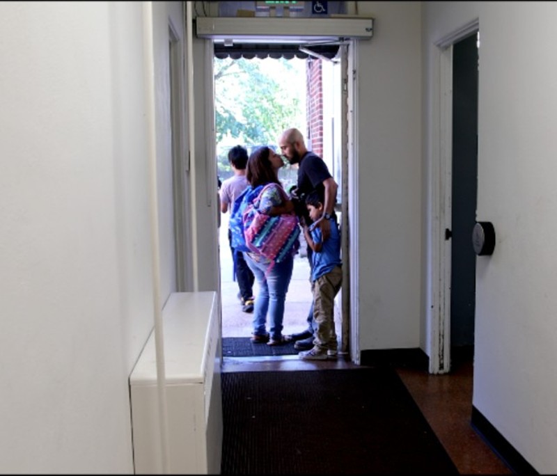 Alex Garcia kisses Carly goodbye while their son Xander clings to his leg at the door of Christ Church in the new film, The Garcia Family. - MISSION MAN MEDIA