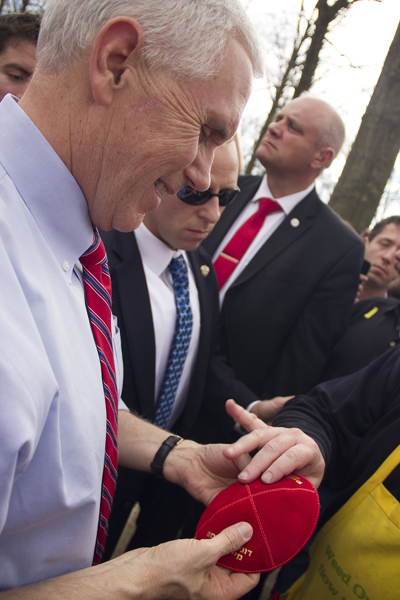 Vice President Mike Pence examines a yarmulke handed to him by Marc Daniels. - Photo by Danny Wicentowski