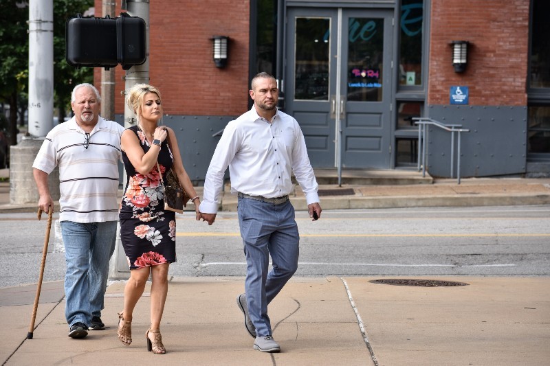 Ex-St. Louis police officer Dustin Boone walks to federal court on June 17 with his wife, Ashley Marie Boone. - DOYLE MURPHY