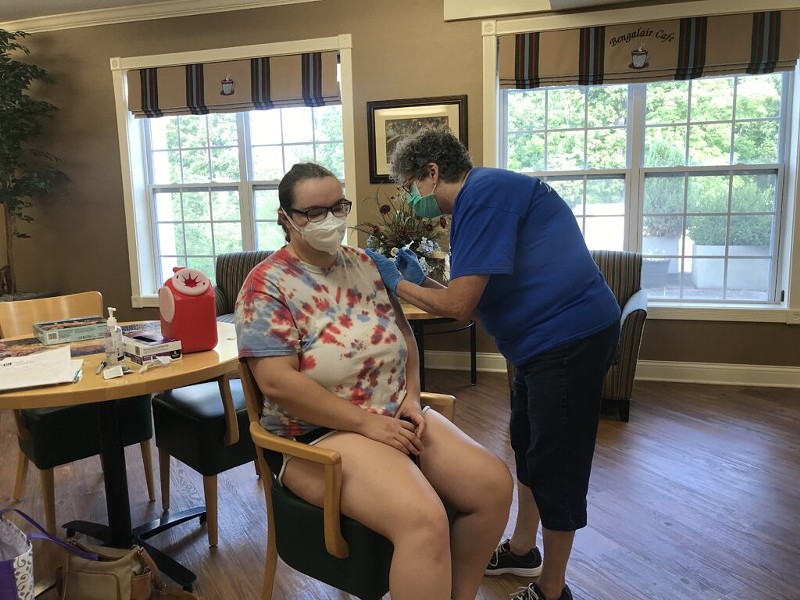 Regina Murdock, a registered nurse with D&H Drugstore, administers a dose of the Pfizer vaccine to Kali Lindsay, a dietary aide, on Aug. 6, 2021 at a clinic at the Neighborhoods by TigerPlace in Columbia, Missouri. - TESSA WEINBERG/MISSOURI INDEPENDENT