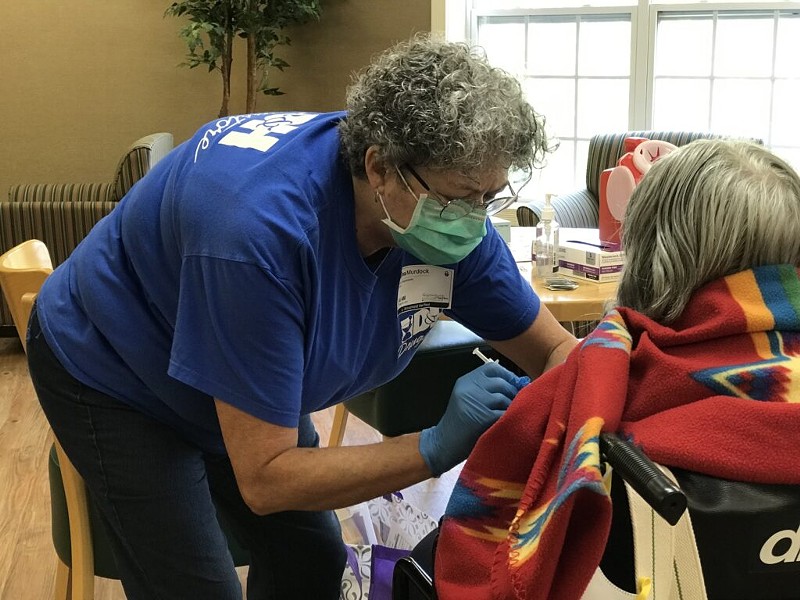 Regina Murdock, a registered nurse with D&H Drugstore, administers a dose of the Pfizer vaccine to a resident on Aug. 6, 2021, at a clinic at the Neighborhoods by TigerPlace in Columbia, Missouri. - TESSA WEINBERG/MISSOURI INDEPENDENT
