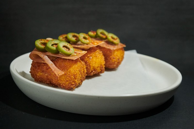 Croquettes with country ham, olives and sherry vinaigrette. - GREG RANNELS
