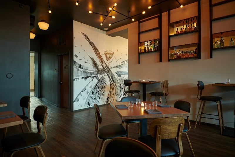 A modern, black and white painting graces the walls of Tempus' dining room. - GREG RANNELS