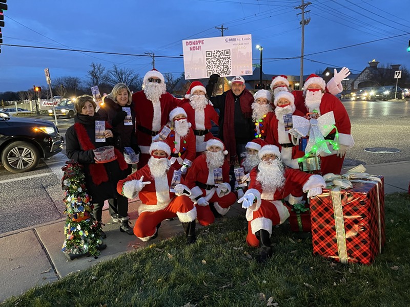 The Dancing Santas, a group comprised of DJ Reggie and the Hip Hop Mamas, danced at the intersection of Clayton and Lindbergh this weekend. - COURTESY KATIE LEIGHTON / DANCING SANTAS